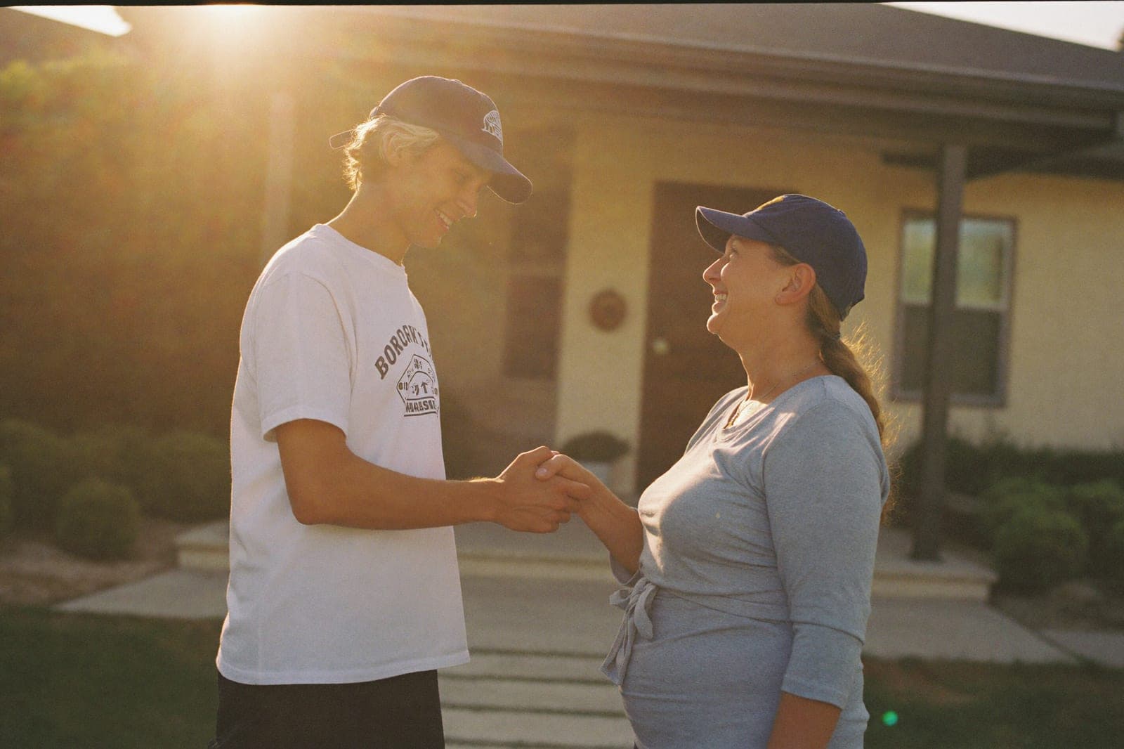 A home-service professional shaking hands with a happy homeowner at their front door
